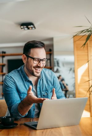 A man smiling at his computer