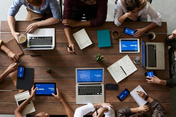 people at table making plan with computers