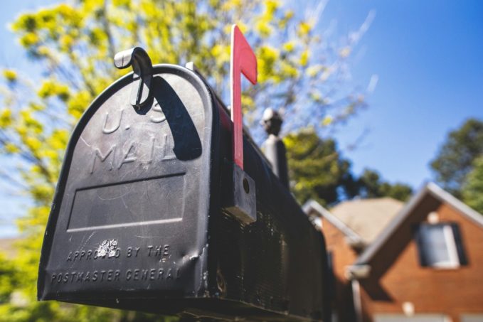 black mailbox with red flag standing up