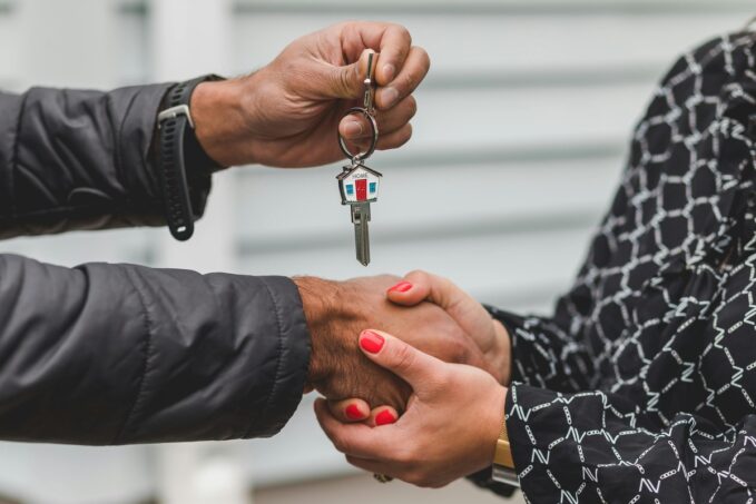 real estate agent handing over keys to buyer